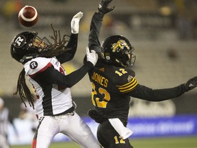 Hamilton Tiger-Cats wide receiver Mike Jones (12) can not get his hands on the ball while defended by Ottawa Redblacks Sherrod Baltimore during second half CFL Football game action in Hamilton, Ont. on Saturday, October 27, 2018.