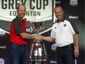 Calgary Stampeders head coach Dave Dickenson (left) and Ottawa Redblacks head coach Rick Campbell (right) shake hands before addressing the media in Edmonton on Wednesday November 21, 2018.