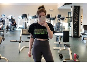 MacKenzie Parsons poses in this gym selfie at St. Thomas University in Fredericton in this recent handout photo. A Fredericton student who was told that the crop top she wore to a campus gym was too distracting, will get an apology from St. Thomas University. MacKenzie Parsons says she was embarrassed and shocked when a male student, who was working at the gym, warned her that there was a policy being developed that would not allow crop tops. The 21-year-old took to social media to complain, and noted that male students often went shirtless or wore muscle shirts that were ripped down the sides.