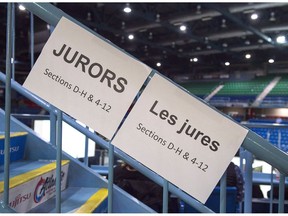 Signage directs potential jurors at jury selection for the retrial of Dennis Oland in the bludgeoning death of his millionaire father, Richard Oland, at Harbour Station arena in Saint John, N.B., on Monday, Oct. 15, 2018. The decision by a judge to declare a mistrial in the high-profile Dennis Oland murder case in New Brunswick has raised difficult questions about the level of police involvement in vetting people selected for jury duty.