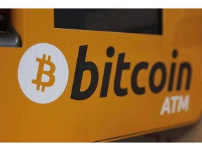 A Bitcoin logo is shown is displayed on an ATM in Hong Kong on December 21, 2017. On Sept. 10, municipal employees in a region between Montreal and Quebec City arrived at work to discover a threatening message on their computers notifying them they were locked out of all their files.