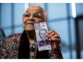 Wanda Robson, sister of Viola Desmond, holds the new $10 bank note featuring Desmond during a press conference in Halifax on Thursday, March 8, 2018. A new $10 banknote featuring Viola Desmond's portrait will go into circulation in a week, just over 72 years after she was ousted from the whites-only section of a movie theatre in New Glasgow, N.S.