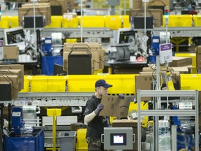 An employee works at the Amazon fulfillment centre in Brampton, Ont. on Monday, November 26, 2018. The centre expects to process 2.5 million packages during the period between Black Friday and Cyber Monday.