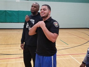 Haidar El Badry, right, at an OPS Hoopstars pick-up game with Const. Chabine Tucker after learning he'd been accepted as a constable by Ottawa police.