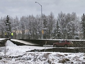 A car is trapped on a collapsed section of the offramp off of Minnesota Drive in Anchorage, Friday, Nov. 30, 2018. Back-to-back earthquakes measuring 7.0 and 5.8 rocked buildings and buckled roads Friday morning in Anchorage, prompting people to run from their offices or seek shelter under office desks, while a tsunami warning had some seeking higher ground.