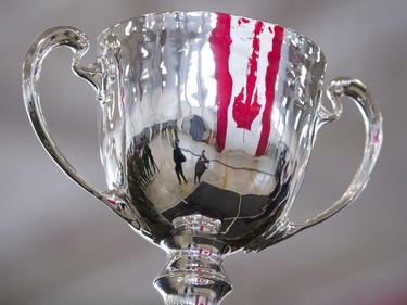 A Canadian flag is reflected in the Grey Cup.