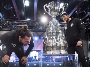 Ottawa Redblacks defensive back Jean-Philippe Bolduc (20) and tight end Marco Dubois (89) pose with the Grey Cup during Grey Cup media day in Edmonton, Alta., on Thursday, Nov. 22, 2018.