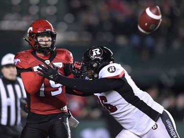 Ottawa Redblacks defensive lineman Michael Wakefield (96) tries to sack Calgary Stampeders quarterback Bo Levi Mitchell (19) during the first half of the 106th Grey Cup at Commonwealth Stadium in Edmonton, Sunday, November 25, 2018.