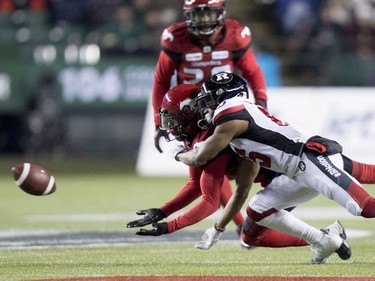 Calgary Stampeders defensive back Emanuel Davis (8) and Ottawa Redblacks wide receiver Diontae Spencer (85) dive for the balll during the first half of the 106th Grey Cup in Edmonton, Alta. Sunday, Nov. 25, 2018.