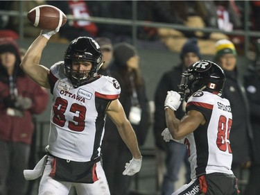 Ottawa Redblacks wide receiver Julian Feoli-Gudino (83) spikes the ball as he celebrates his touchdown with teammate wide receiver Diontae Spencer (85) during the first half of the 106th Grey Cup against the Calgary Stampeders in Edmonton, Sunday, November 25, 2018.