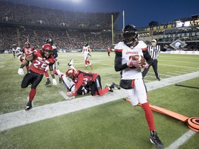 Calgary Stampeders running back Don Jackson (25) tries to catch Ottawa Redblacks defensive back Jonathan Rose (9) during the first half of the 106th Grey Cup in Edmonton, Alta. Sunday, Nov. 25, 2018.