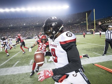 Calgary Stampeders running back Don Jackson (25) tries to catch Ottawa Redblacks defensive back Jonathan Rose (9) during the first half of the 106th Grey Cup in Edmonton, Alta. Sunday, Nov. 25, 2018.