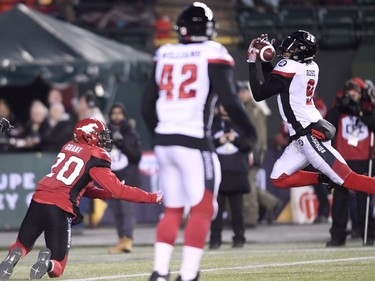 Ottawa Redblacks defensive back Jonathan Rose (9) intercepts the ball from Calgary Stampeders wide receiver Bakari Grant (20) during the first half of the 106th Grey Cup at Commonwealth Stadium in Edmonton, Sunday, November 25, 2018.