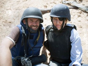 This image released by Arrow Media shows photographer Paul Conroy, left, with war correspondent Marie Colvin in Misrata, Libya. A new documentary recounts in searing detail the final days of Colvin, who was killed in shelling from Syrian President Bashar Assad's forces in 2012 in the city of Homs, where she was documenting civilian suffering.