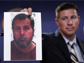 Timothy Wiley, FBI public affairs specialist, holds a photo Amor Ftouhi after a news conference in Detroit, Thursday, June 22, 2017. Amor Ftouhi, a Canadian man, shouted in Arabic before stabbing a police officer in the neck at the Bishop International Airport in Flint, Mich., on Wednesday, and referenced people being killed overseas during the attack that's now being investigated as an act of terrorism, federal officials said.