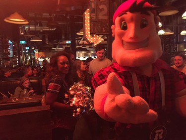 Grey Cup fans celebrate with the RedBlacks mascot Big Joe. Aedan Helmer/Postmedia