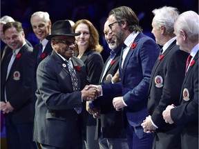 Hockey Hall of Fame inductee Willie O'Ree shakes hands with HHoF personalities before NHL action between the Toronto Maple Leafs and the New Jersey Devils, in Toronto on Friday, Nov. 9, 2018.