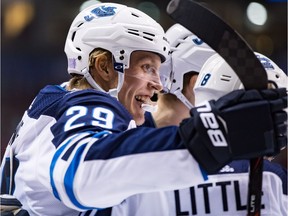 Winnipeg Jets' Patrik Laine (29), of Finland, and Bryan Little (18) celebrate Little's goal against the Vancouver Canucks during the first period of an NHL hockey game in Vancouver, on Monday November 19, 2018.