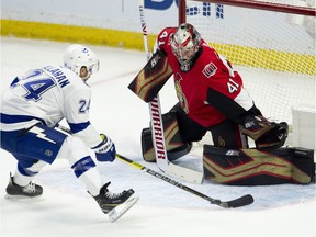 Tampa Bay Lightning right wing Ryan Callahan tries to stickhandle the puck past Ottawa Senators goaltender Craig Anderson during first period NHL action in Ottawa, Sunday, Nov. 4, 2018.