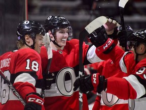 Drake Batherson (79) is congratulated by Ottawa Senators teammates after scoring in his NHL debut in Ottawa on Thursday, Nov. 15, 2018.