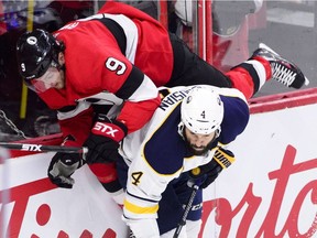 Ottawa Senators right wing Bobby Ryan gets hit by Buffalo Sabres defenseman Zach Bogosian during first period NHL hockey action in Ottawa on Thursday, Nov. 1, 2018.