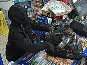 Heavily disguised robbery suspect in convenience store holdup.