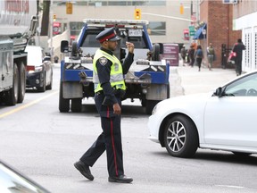 A police officer directs traffic on Waller Street.
