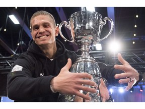 Ottawa Redblacks quarterback Trevor Harris (7) poses with the Grey Cup during Grey Cup media day in Edmonton, Alta. Thursday, Nov. 22, 2018. The Ottawa Redblacks will play the Calgary Stampeders in the 106th Grey Cup on Sunday.