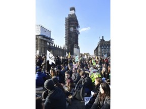 Demonstrators on Westminster Bridge in London, Saturday Nov. 17, 2018, for a protest group called 'Extinction Rebellion' to raise awareness of the dangers posed by climate change. Hundreds of protesters turned out in central London and blocked off the capital's main bridges to demand the government take climate change seriously.