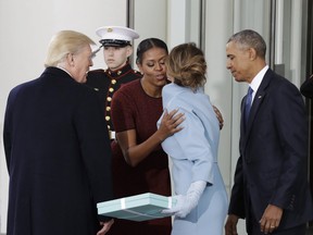 In this Jan. 20, 2017 file photo, first lady Michelle Obama, flanked by President Barack Obama and then President-elect Donald Trump, greets Melania Trump at the White House in Washington.