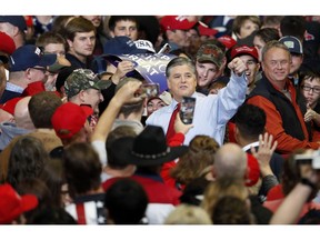 Television personality Sean Hannity points as he meets with members of the audience before the start of a campaign rally Monday, Nov. 5, 2018, in Cape Girardeau, Mo., with President Donald Trump.