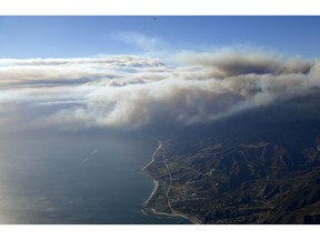 Fires burn toward the pacific ocean as seen Friday, Nov. 9, 2018, from a helicopter over Santa Monica, Calif. Flames driven by powerful winds torched dozens of hillside homes in Southern California, burning parts of tony Calabasas and mansions in Malibu and forcing tens of thousands of people -- including some celebrities -- to flee as the fire marched across the Santa Monica Mountains toward the sea.