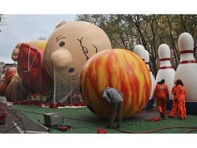 Giant character balloons, including Charlie Brown and Go Bowling, are inflated the night before their appearance in the 92nd Macy's Thanksgiving Day parade, Wednesday Nov. 21, 2018, in New York.