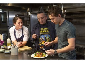 FILE - In this Nov. 12, 2018 file photo, chef Jessica Largey, left, looks on as director Joe Russo, center, and actor Tom Holland taste a dish she just cooked at the Cooking with "The Avengers" event at the Simone Restaurant in Los Angeles. Holland received the cooking lesson with "Avengers" co-director Russo and Largey who introduced him to kabocha squash, a delicacy known as Japanese pumpkin.