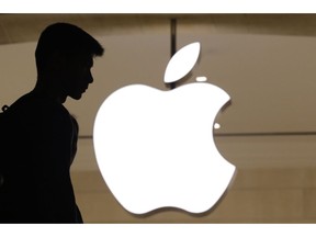 FILE - In this May 31, 2018, file photo, a customer enters an Apple store in New York. Since stocks began tumbling in September 2018, investors haven't abandoned the market. At least, not all of it. Apple has slumped particularly hard on fears that its newest crop of iPhones isn't as popular as expected after some phone-part suppliers gave discouraging forecasts.