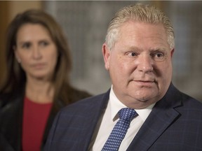 Ontario Premier Doug Ford, with Caroline Mulroney in the background, has altered some of his cuts to French language funding, but the damage is done.