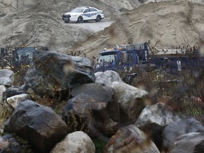 Quebec police sit near a fatal work related accident on Highway 105 near Low Quebec Friday Nov 2, 2018. The accident buried a man alive with sand while he was working in a machine.  Tony Caldwell