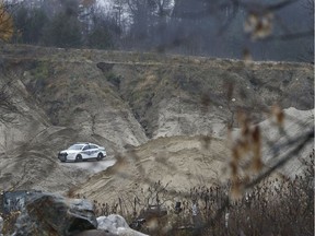 Quebec police sit near a fatal work related accident on Highway 105 near Low Quebec Friday Nov 2, 2018. The accident buried a man alive with sand while he was working in a machine.  Tony Caldwell