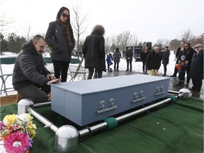 Bruce and sister Michelle stand at Sandy's grave Monday. Tony Caldwell