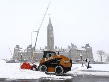 Crews clear the snow on Parliament Hill after a overnight snow storm in Ottawa Friday Nov 17, 2018.