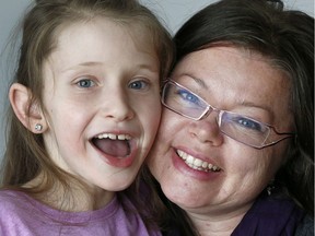 Oceane McKenzie, 9, and her mother Vicki at home in Gatineau. The construction community has pitched in to build a new home for Oceane.