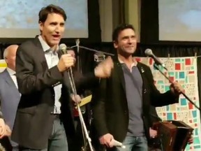 Prime Minster Justin Trudeau sings with actor Allan Hawco at a Newfoundland "shed party" on the Hill on Nov. 21, 2018. (image taken from video posted to twitter via @SeamusORegan)