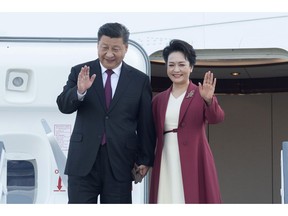 Chinese President Xi Jinping and his wife Peng Liyuan wave on arrival in Madrid, Spain, Tuesday Nov. 27, 2018. Chinese president Xi Jinping has arrived Tuesday in Spain for the first leg of an international tour that will cover a global summit in Argentina and visits to Panama and Portugal.