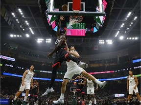 Toronto Raptors' Pascal Siakam shoots past Milwaukee Bucks' Ersan Ilyasova.