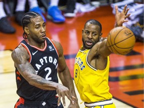 The Toronto Raptors' Kawhi Leonard battles during overtime action against the Golden State Warriors' Andre Iguodala at the Scotiabank Arena in Toronto, Ont. on Thursday November 29, 2018.