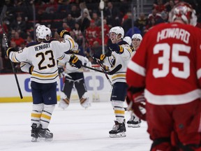 Buffalo Sabres center Sam Reinhart (23) celebrates with teammates after his winning goal past Detroit Red Wings goaltender Jimmy Howard (35) during the shootout of an NHL hockey game, Saturday, Nov. 24, 2018, in Detroit. Buffalo won, 3-2, in shootout.