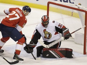 Ottawa Senators goaltender Mike McKenna  defends the net against Florida Panthers center Nick Bjugstad during the second period of an NHL hockey game on Sunday, Nov. 11, 2018