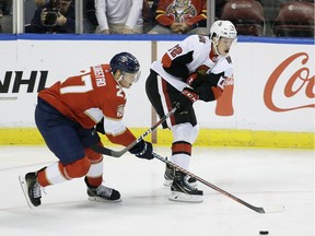 Florida Panthers center Nick Bjugstad (27) and Ottawa Senators defenseman Thomas Chabot (72) fight for the puck during the first period of an NHL hockey game on Sunday, Nov. 11, 2018 in Sunrise, Fla.