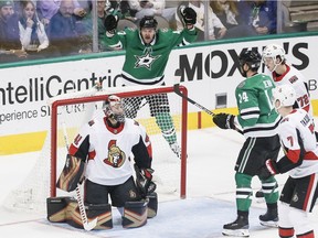 Dallas Stars forward Alexander Radulov, background, reacts after forward Jamie Benn (14) scored a goal against Ottawa Senators goaltender Craig Anderson (41) during the first period of an NHL hockey game on Friday, Nov. 23, 2018, in Dallas.