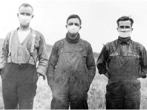Three Alberta farmers stand in a field wearing masks during the influenza epidemic that swept the world, Canada and Ottawa
